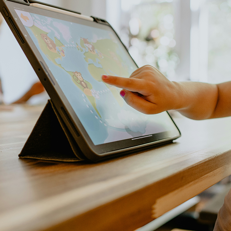 Et barn, der bruger en iPad til leg